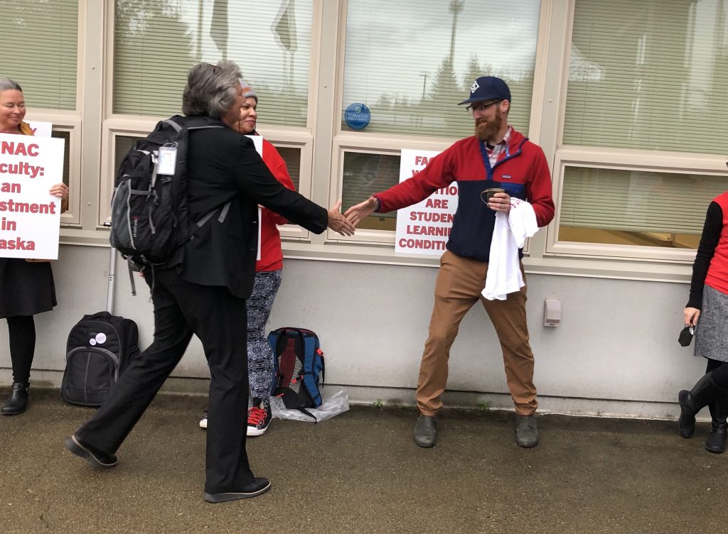 Professor Kevin Maier shakes hands with UA President Pat Pitney before the Sept. 8-9 Board of Regents meeting. PHOTO PROVIDED BY KATE QUICK