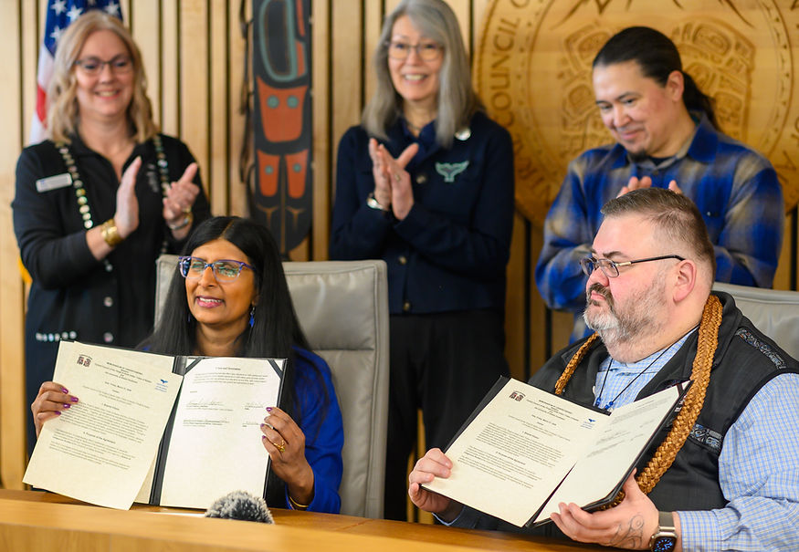 University of Alaska Southeast Chancellor Aparna Palmer and Chalyee Éesh Richard Peterson, president of the Central Council of the Tlingit and Haida Indian Tribes of Alaska, hold up the signed memorandum of understanding to formalize the process of developing a School of Indigenous Studies on Friday, March 27, 2026. (Jasz Garrett / Juneau Independent)